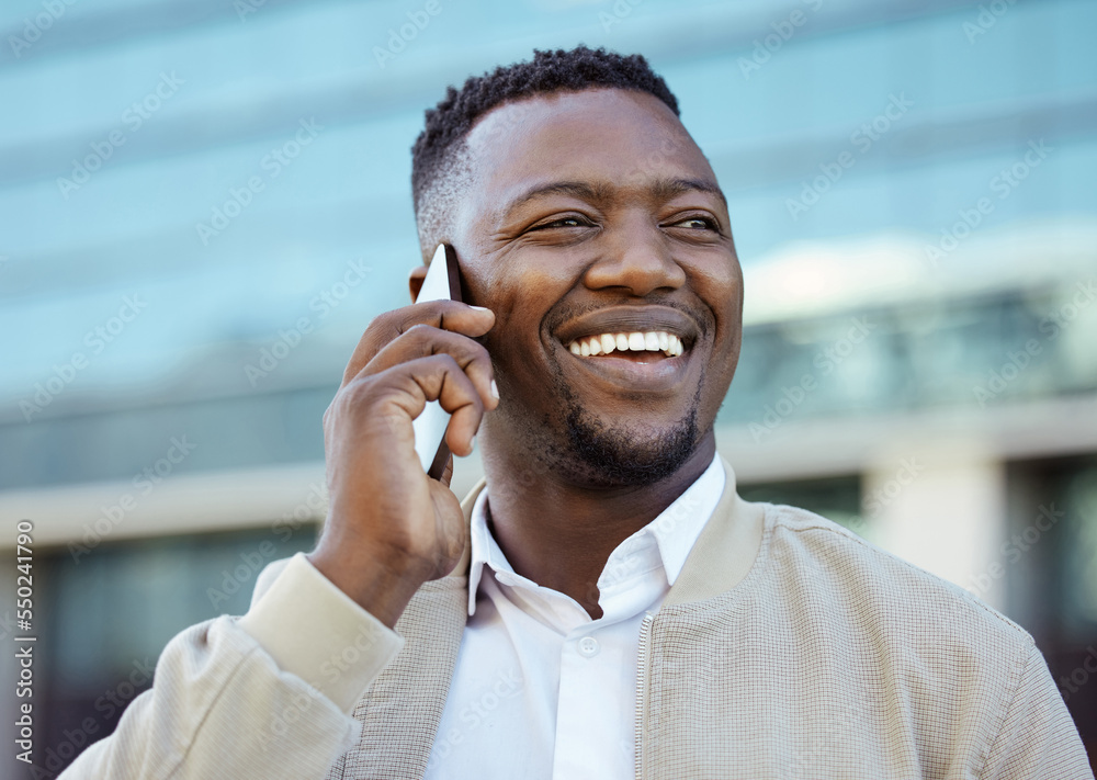 Man on a phone call outside a building in the street receiving news after winning online game. Happy