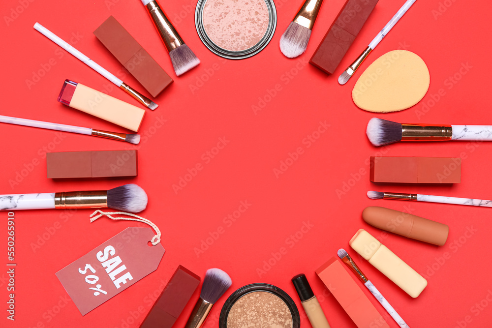 Frame made of cosmetic products and sale tag on red background