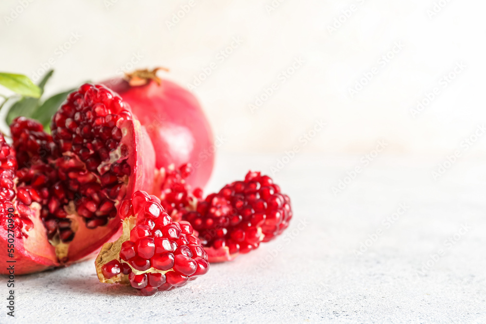 Fresh ripe pomegranates on light background