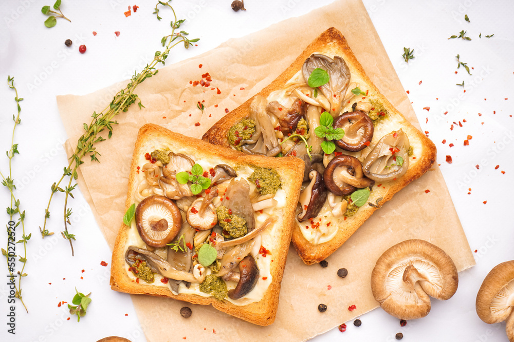 Tasty toasts with cream cheese, mushrooms and spices on light background