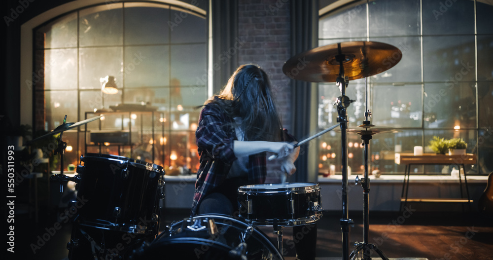 Expressive Drummer Girl Playing Drums in a Loft Music Rehearsal Studio at Night. Rock Band Music Art