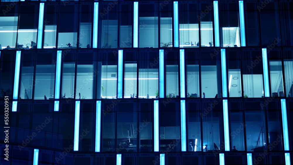 Pattern of office buildings windows illuminated at night. Glass architecture ,corporate building at 