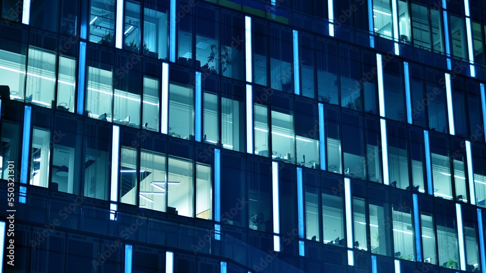 Pattern of office buildings windows illuminated at night. Glass architecture ,corporate building at 