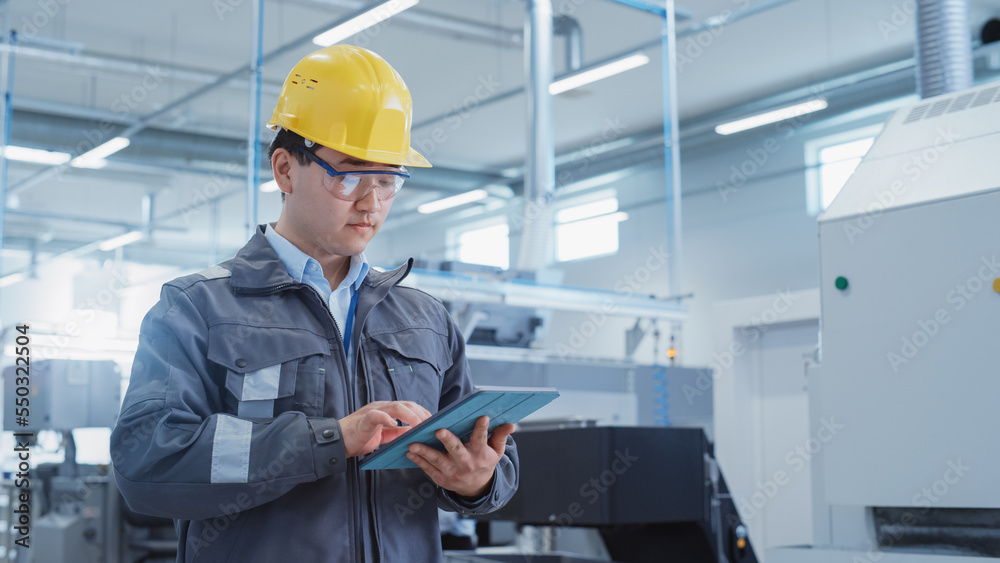 Portrait of a Young Asian Man, Working as an Engineer at a Factory Facility, Wearing Work Jacket and