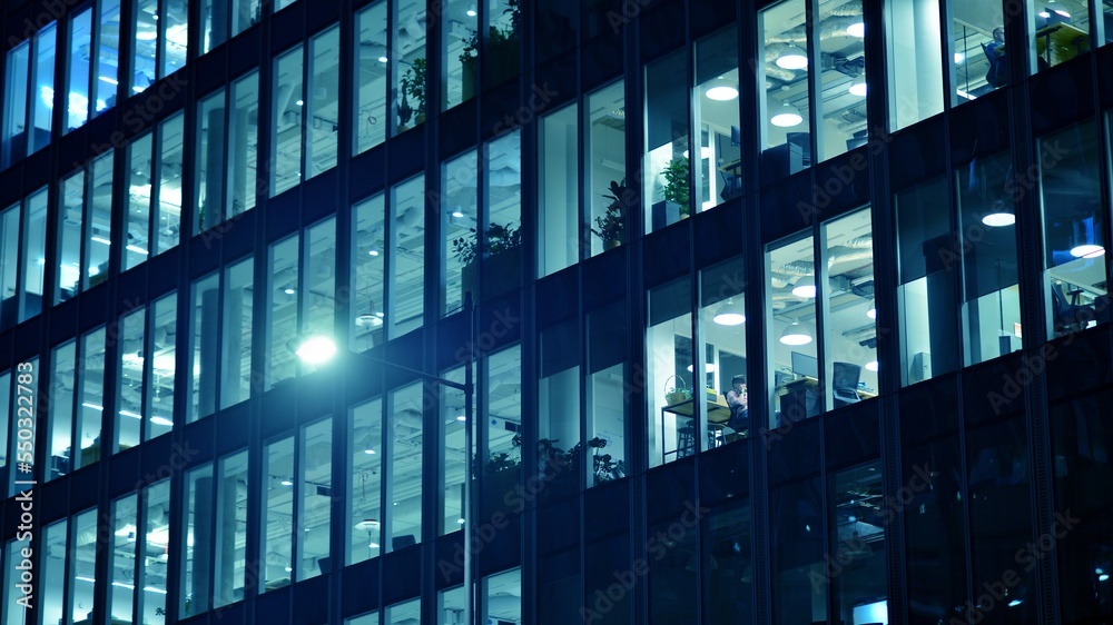 Pattern of office buildings windows illuminated at night. Glass architecture ,corporate building at 