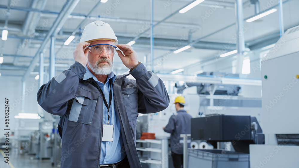 Close Up Portrait of a Middle Aged, Successful Male Engineer in White Hard Hat and Safety Glasses, S