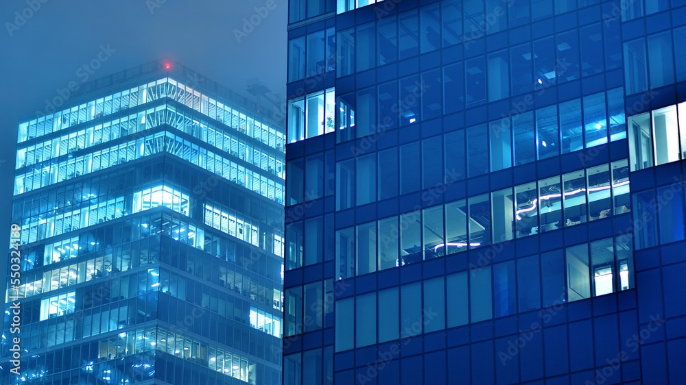 Pattern of office buildings windows illuminated at night. Glass architecture ,corporate building at 