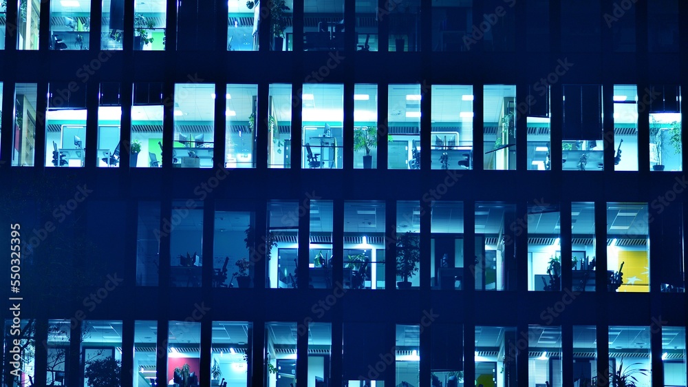 Pattern of office buildings windows illuminated at night. Glass architecture ,corporate building at 