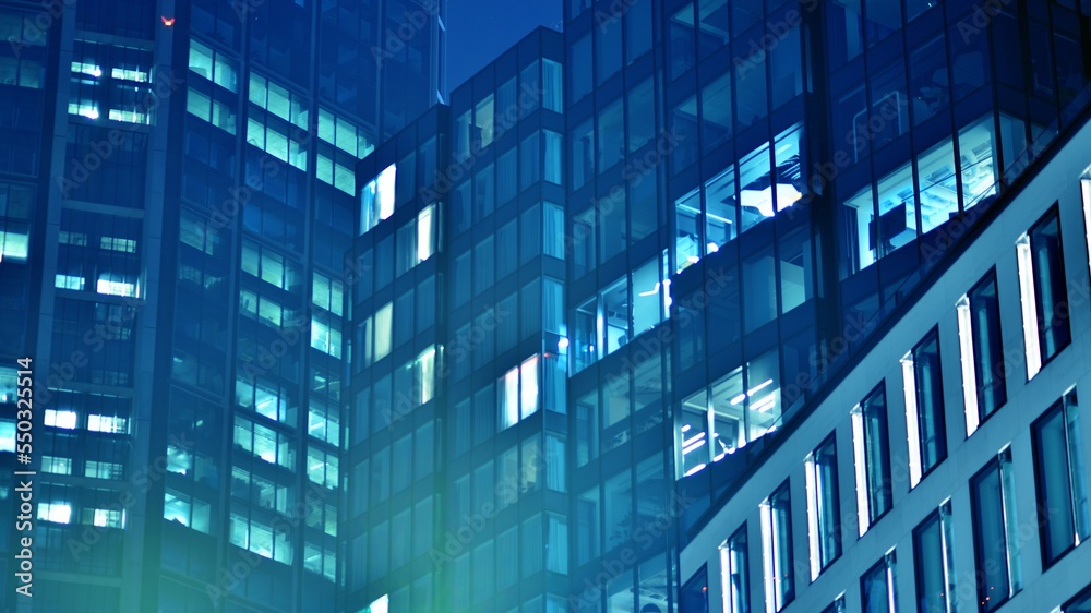 Pattern of office buildings windows illuminated at night. Glass architecture ,corporate building at 