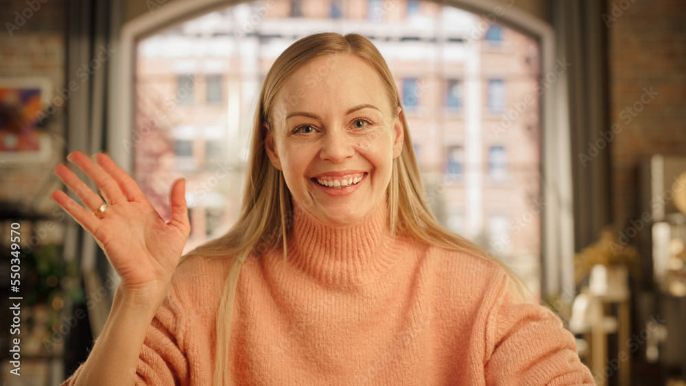 Attractive Young Female Making Video Call from Home Living Room with Big Window. Happy Woman Talking