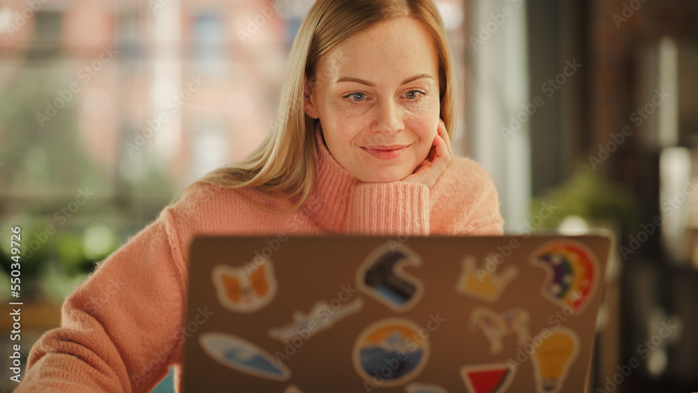 Close Up of a Beautiful Young Adult Woman Using Laptop Computer with LGBT Stickers on the Back in Cr