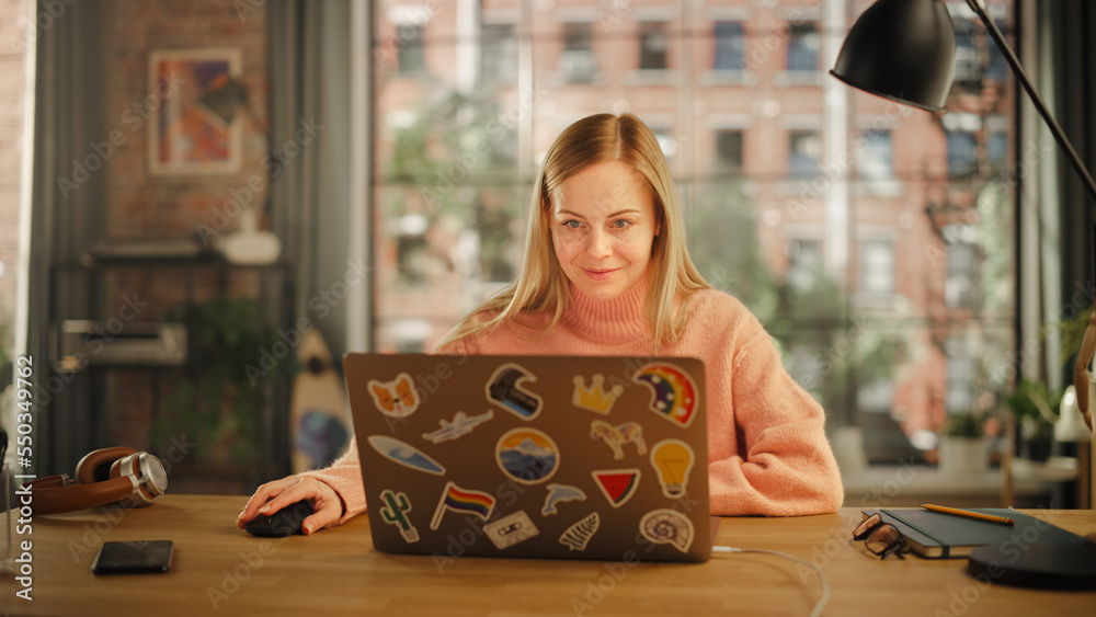 Beautiful Young Woman Working on Laptop Computer while Sitting in Stylish Cozy Creative Office. Free