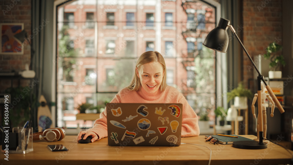 Happy Young Woman Working on Laptop Computer while Sitting in Stylish Creative Office. Successful Fr