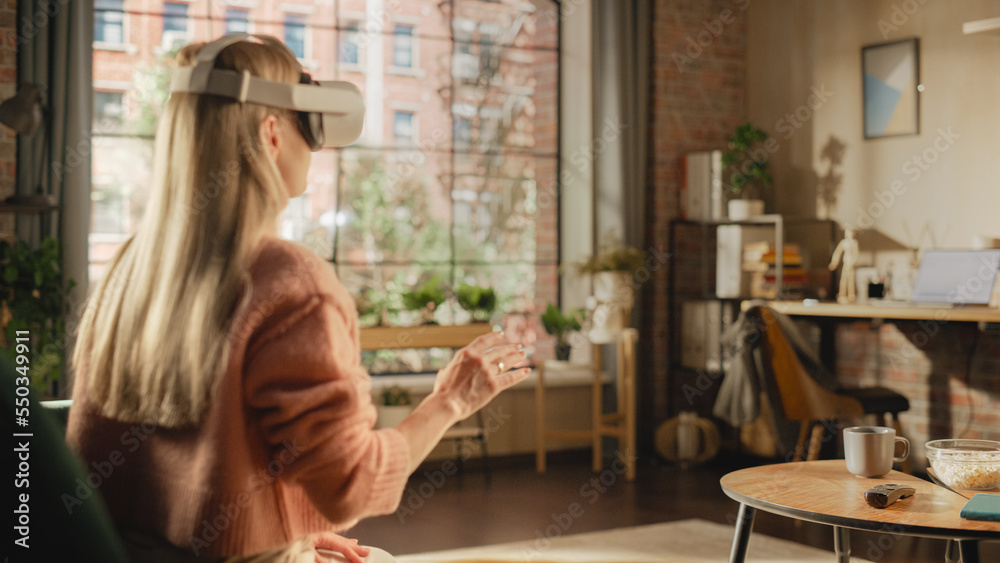 Over the Shoulder Footage of a Female Freelancer Using Virtual Reality Headset and Controllers for H