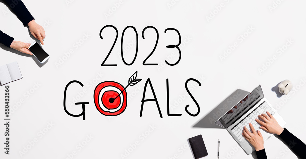 2023 goals concept with people working together with laptop and phone