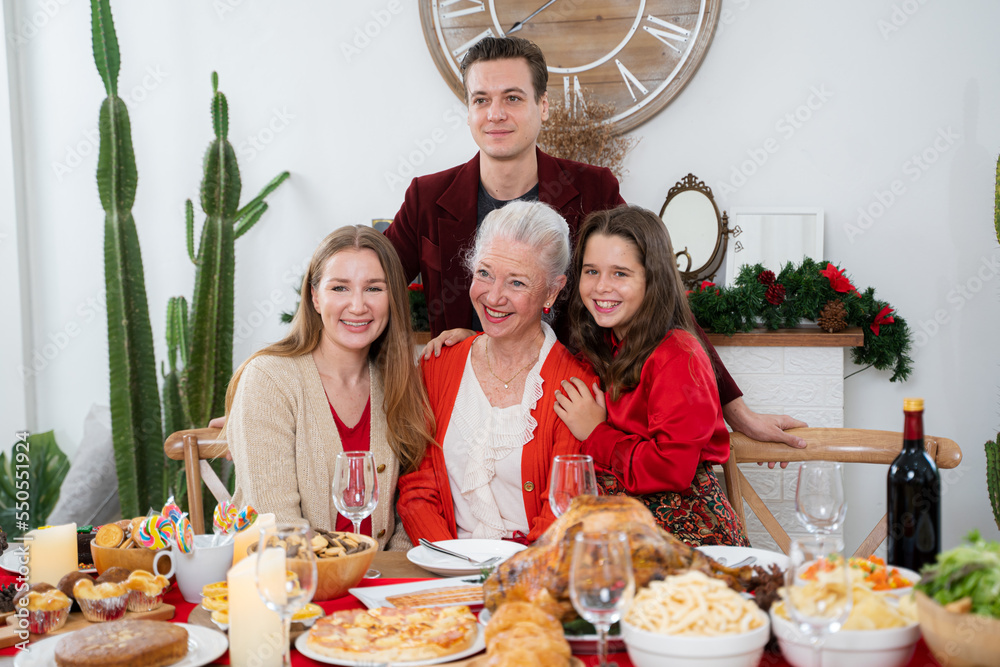 Big family gathering sitting dinner table multi-generation reunion for holiday in new year atmospher