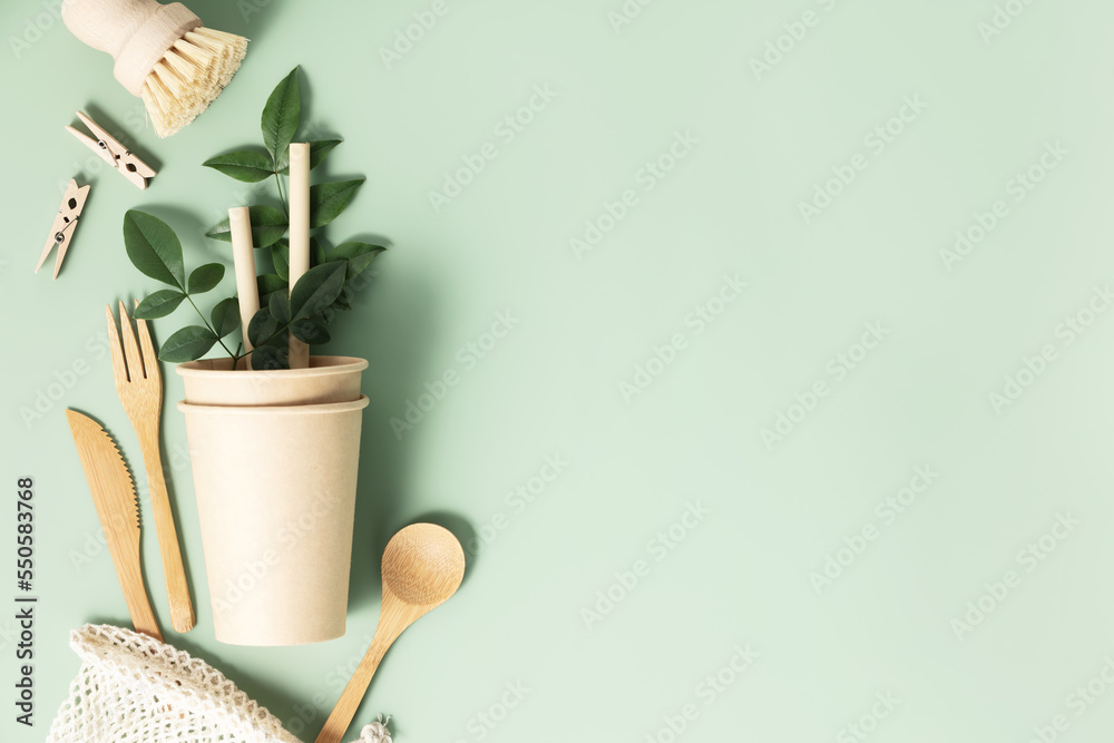 Eco composition with tableware on light green background copy space