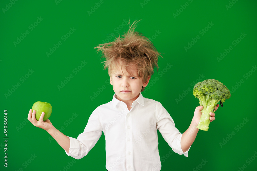 Surprised child against green chalkboard in class