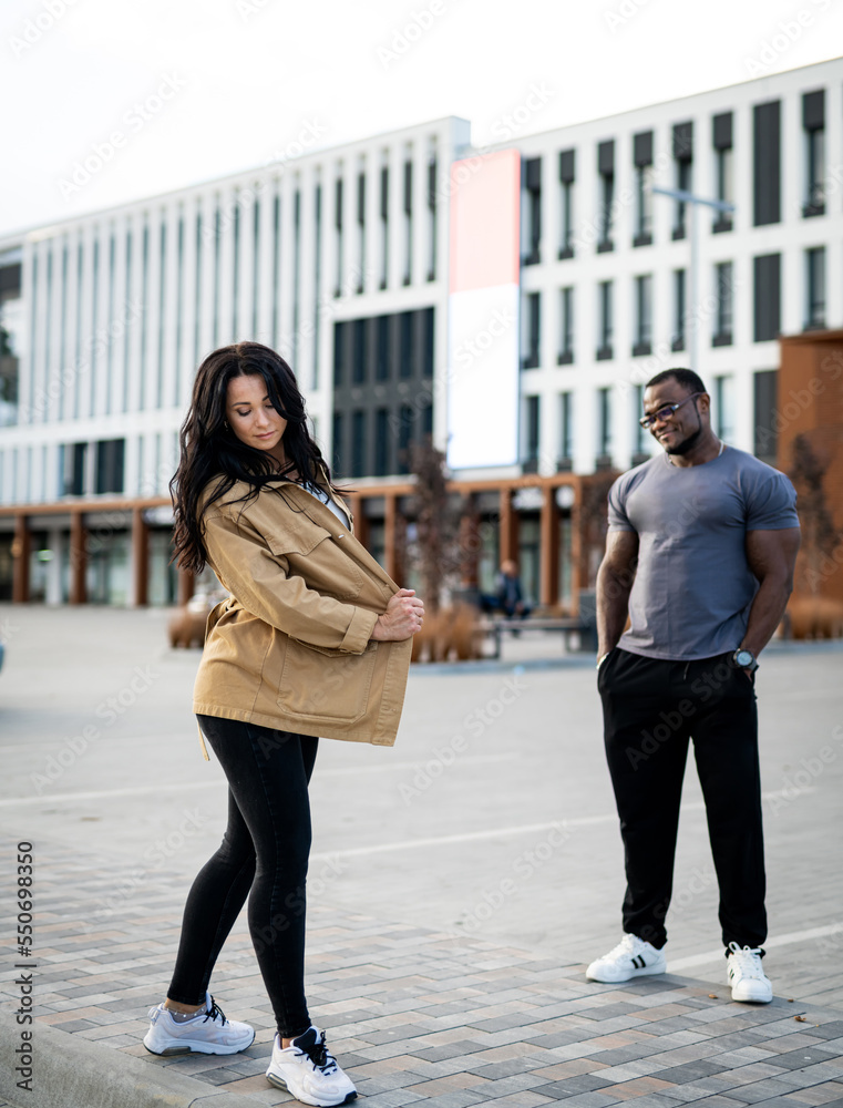 Young fit couple outdoor walking. Happy lifestyle people enjoying outside.