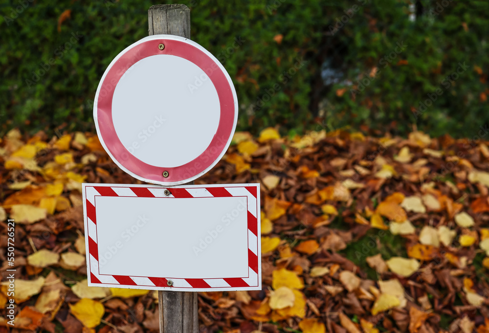 Blank prohibition signboards in autumn park, closeup