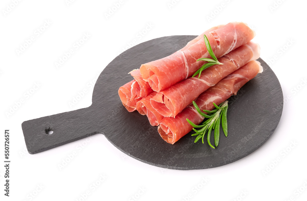 Slate board with rolled slices of tasty ham and rosemary on white background