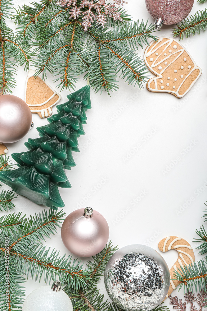 Frame made of Christmas branches, decor and cookies on white background