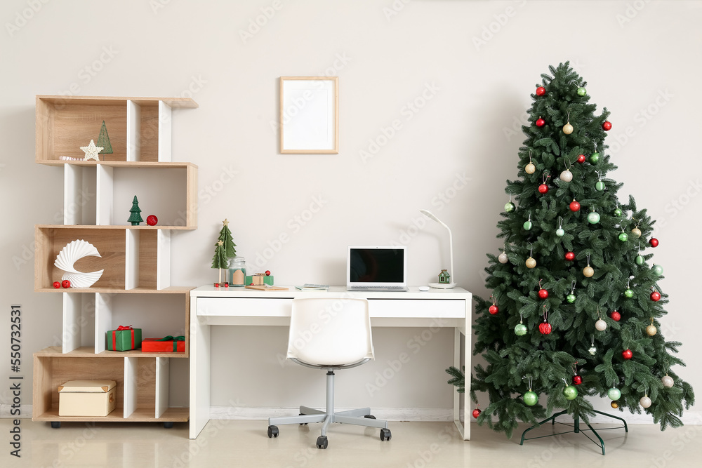 Interior of office with workplace, Christmas trees and presents