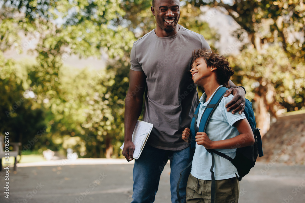 Happy student and teacher standing together outdoors