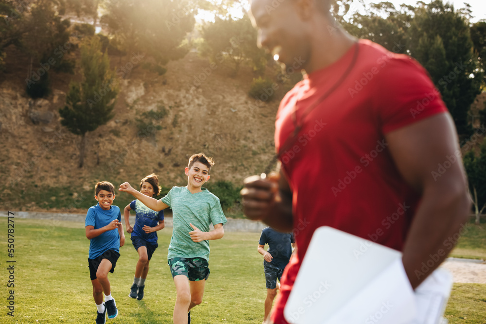 Children running on a school ground during PE