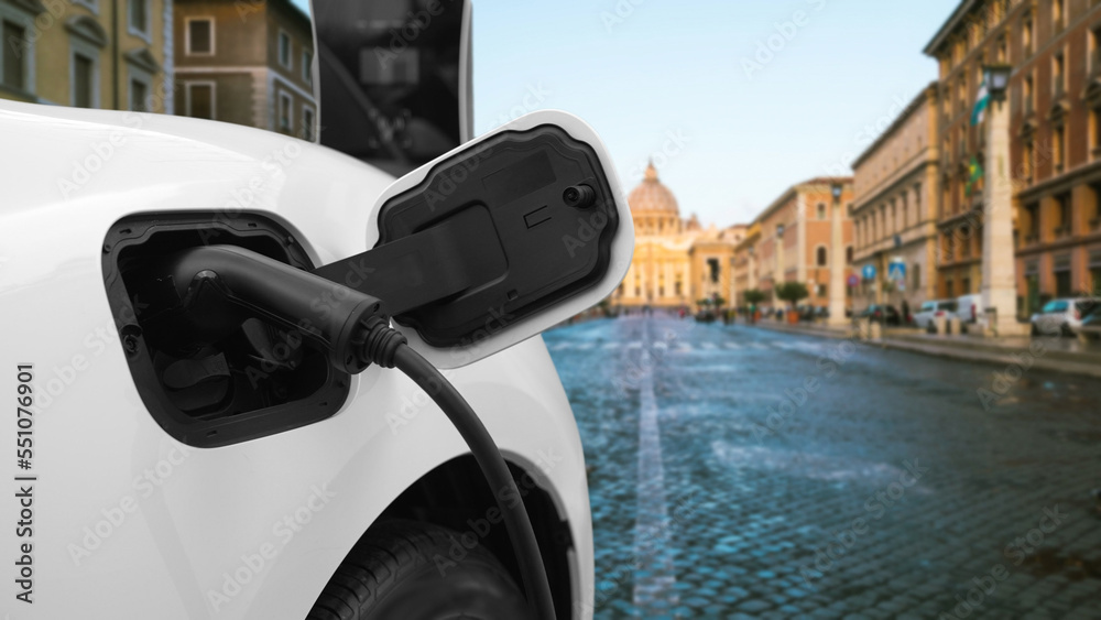 Progressive electric car recharging battery at the charging station in Vatican, historical christian