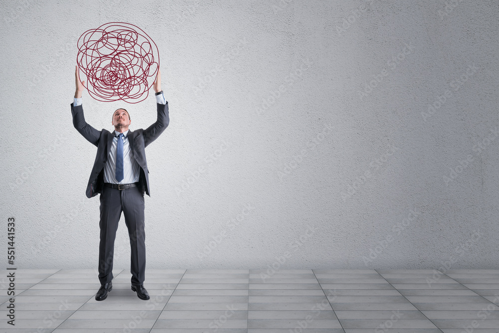 Young european businessman holding scribble of thoughts on concrete wall background with mock up pla