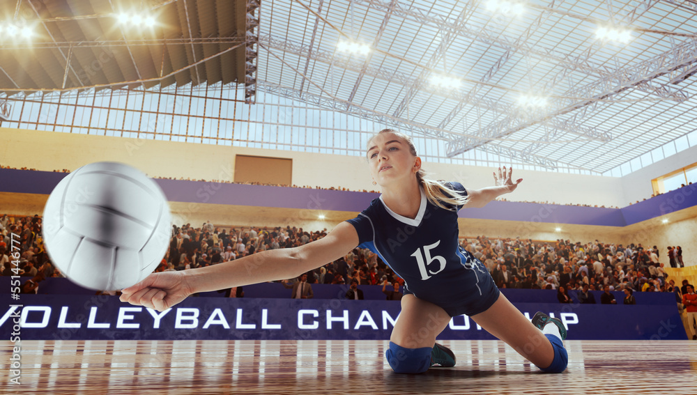 Female volleyball players in action on professional stadium. 