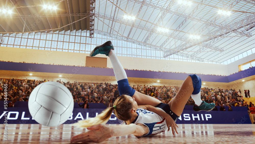 Female volleyball players in action on professional stadium. 