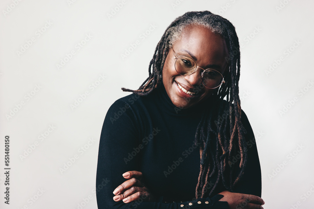 Happy professional woman smiling at the camera in a studio