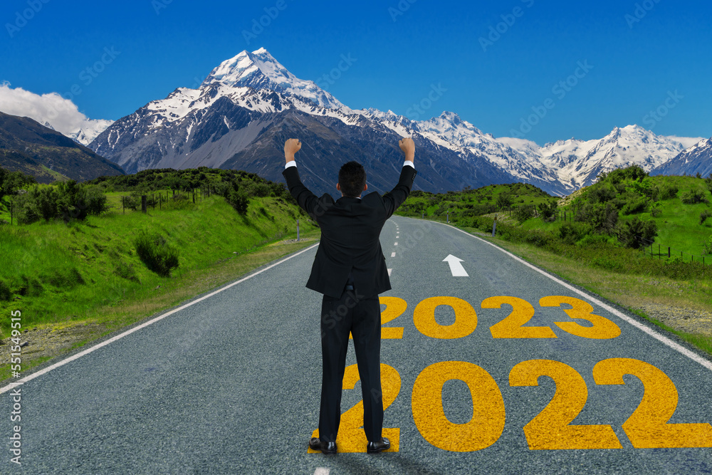 The 2023 New Year journey and future vision concept . Businessman traveling on highway road leading 