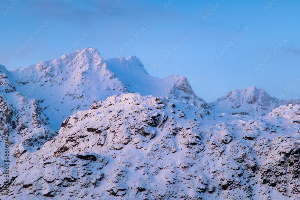 North. Winter landscape during sunset. Bright sky. Mountain peaks during sunset. Snowy winter. Natur