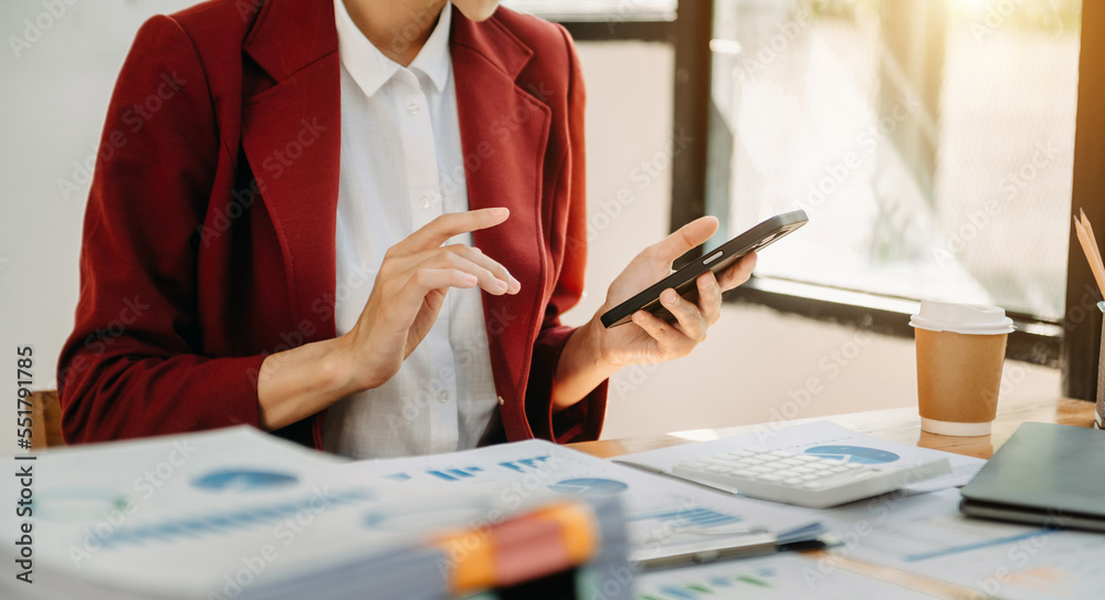 Businesswoman s hands typing on smartphone and  laptop keyboard in morning light computer, typing, o