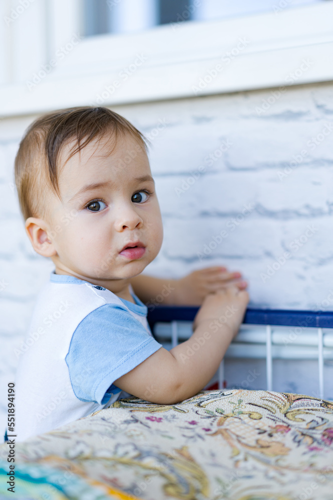 Little toddler boy close up in his house. Handsome toddler portrait. Joyful childhood and parenthood