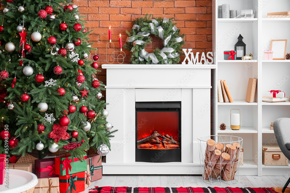 Interior of living room with fireplace, Christmas wreath and fir tree