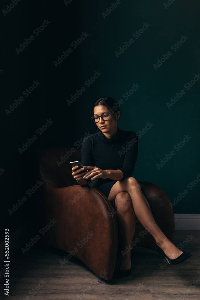 Asian woman using a smartphone in an office