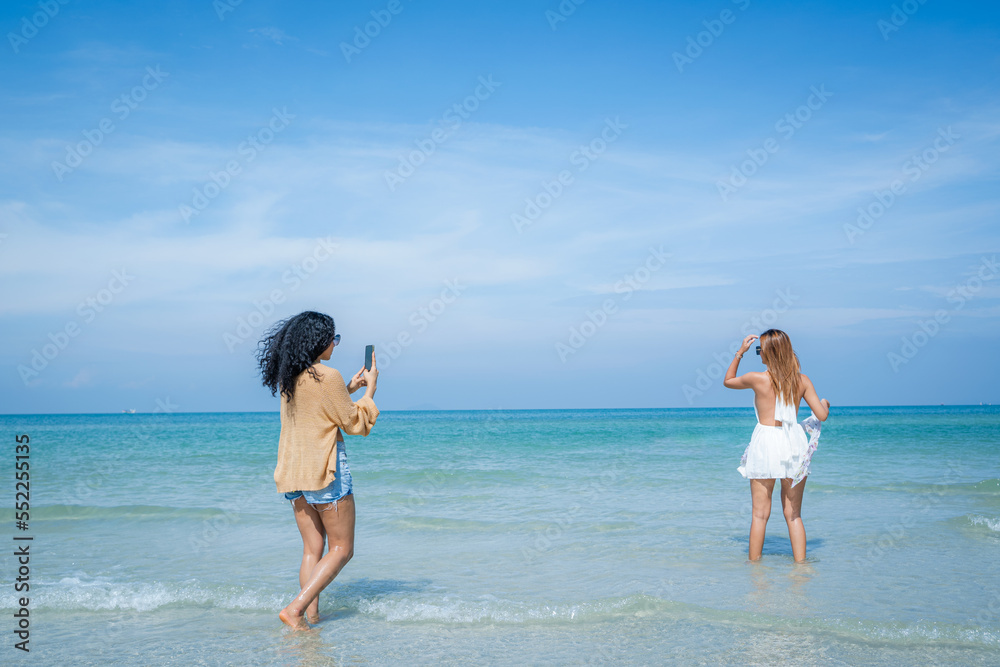 Beautiful girls and friend having fun together on the beach,Nice weather in travel and holiday conce