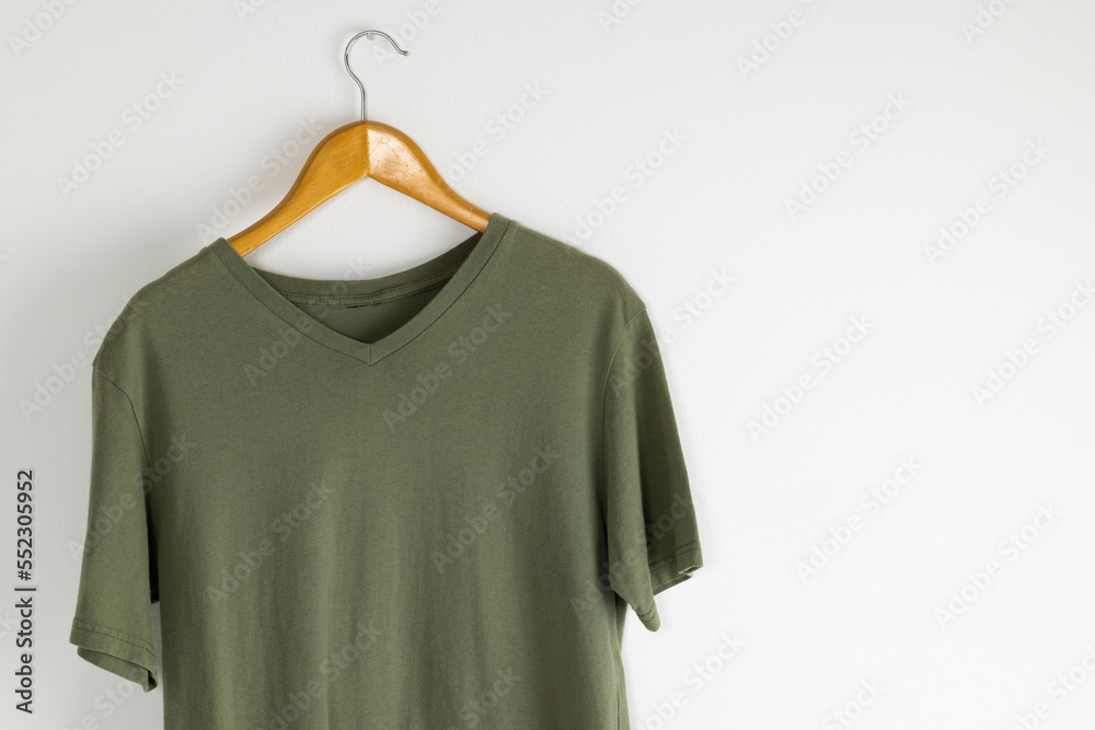 Tshirt hanging on coat hanger and copy space on white background