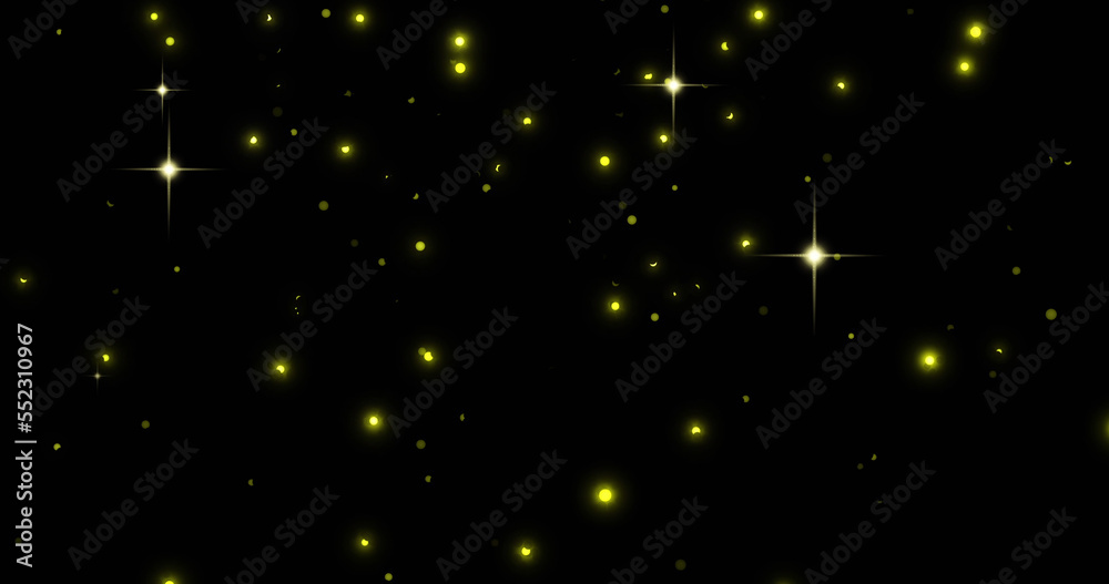 Image of glowing yellow spots falling on black background