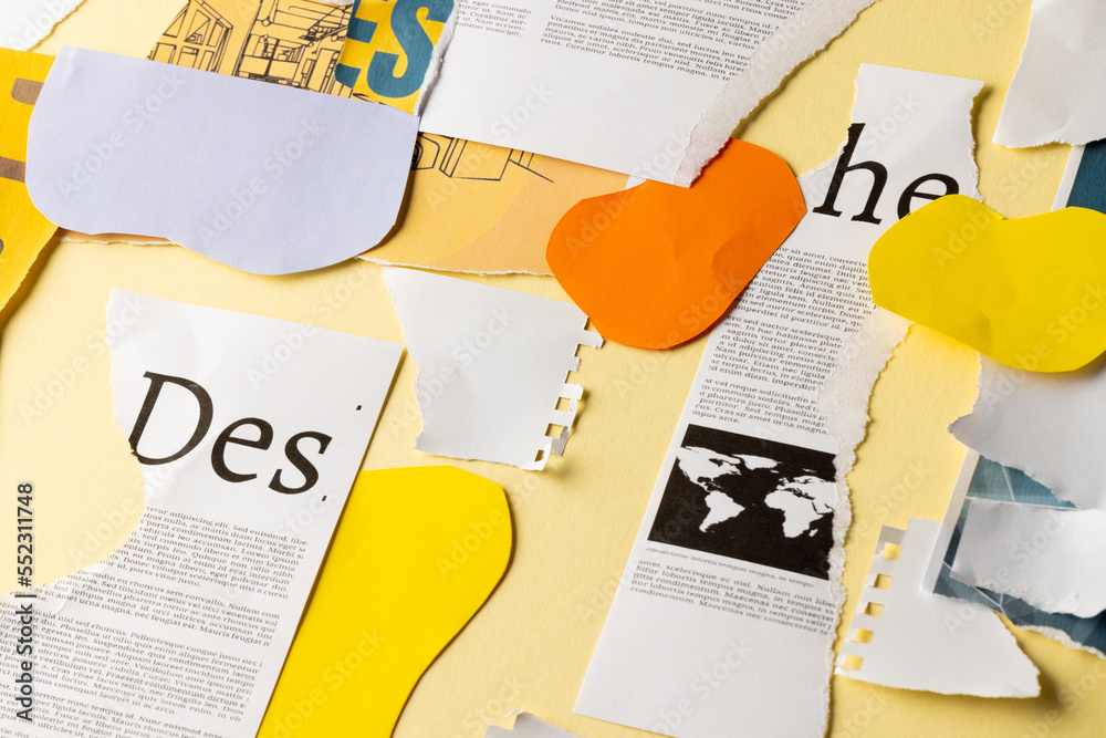 Ripped up pieces of notebooks, newspaper and coloured paper with copyspace on yellow background