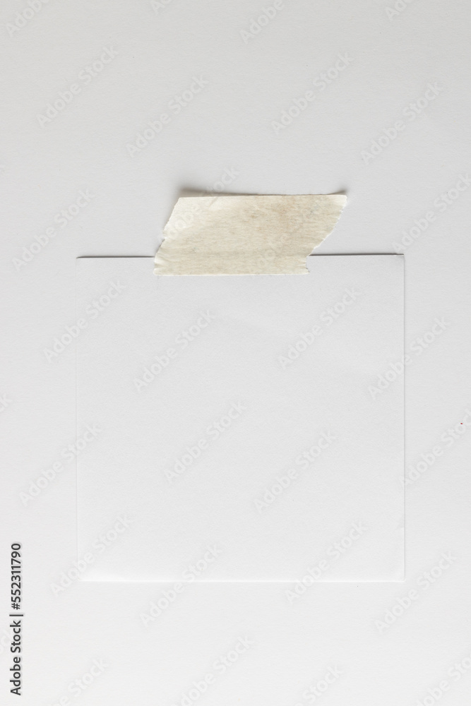 White sticky memo note with tape and copy space on white background