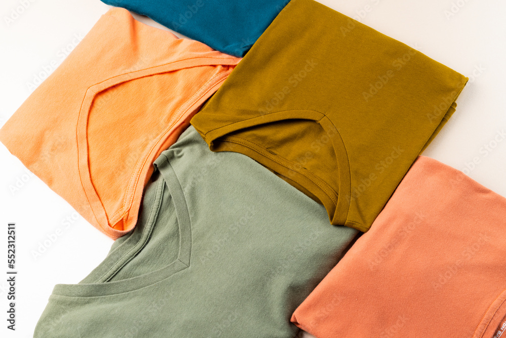 Close up of coloured tshirts and copy space on white background