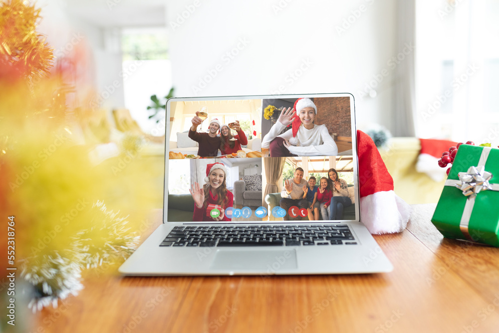 Diverse people having christmas video call on laptop screen