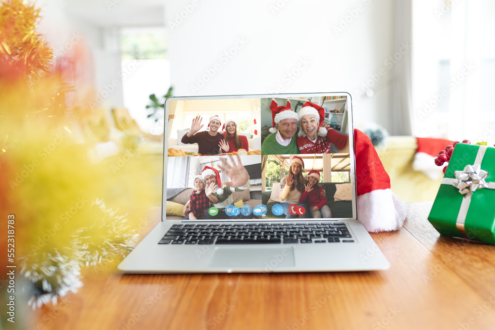 Diverse people having christmas video call on laptop screen