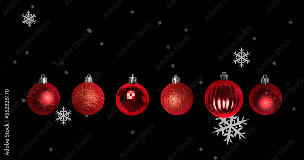 Image of snowflakes falling over christmas baubles on black background