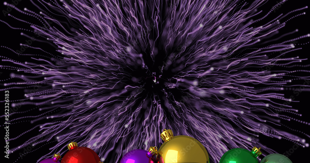 Image of fireworks over christmas baubles on black background